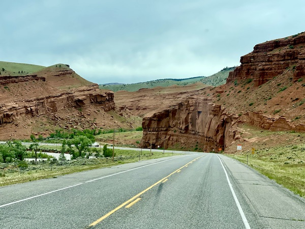 Highway through red rock mountains near Teton Mountain Range Wyoming