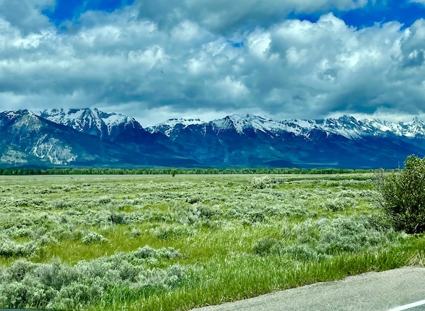 Large expanse of lawn in front of Teton Mountain Range Wyoming