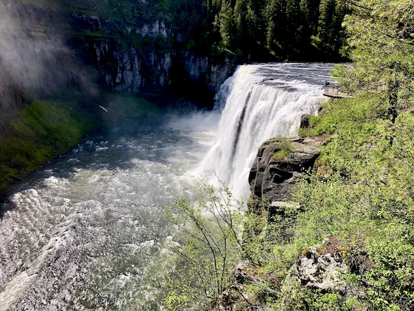 Waterfall and river lined with trees seen while Visiting Ashton Idaho