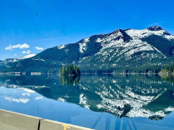 Snow dusted mountain is reflected in lake en route to Visiting Spokane Washington