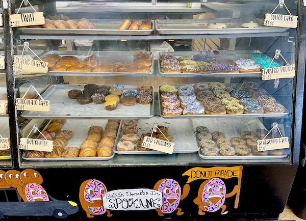 A glass pastry case filled with assorted donuts at Donut Parade in Spokane WA