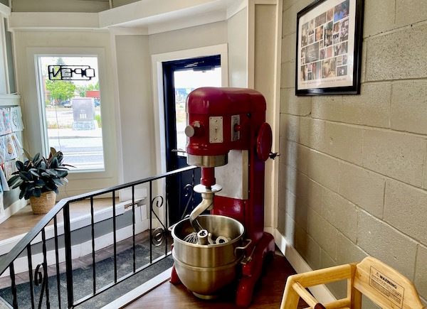 The entry to a bakery with a huge red stand mixer on display seen while Visiting Spokane Washington