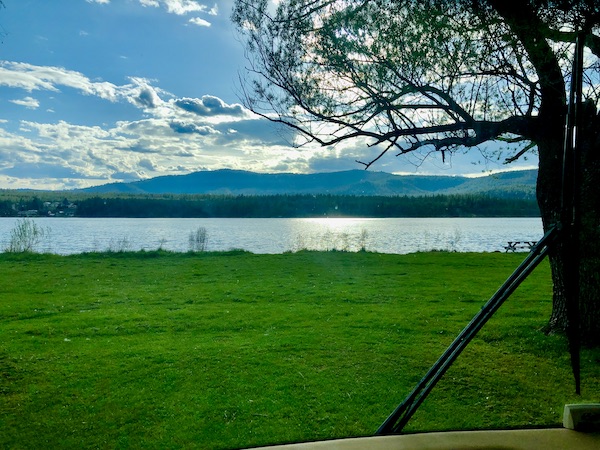 Lawn, lake and mountains at our RV park while Visiting Spokane Washington