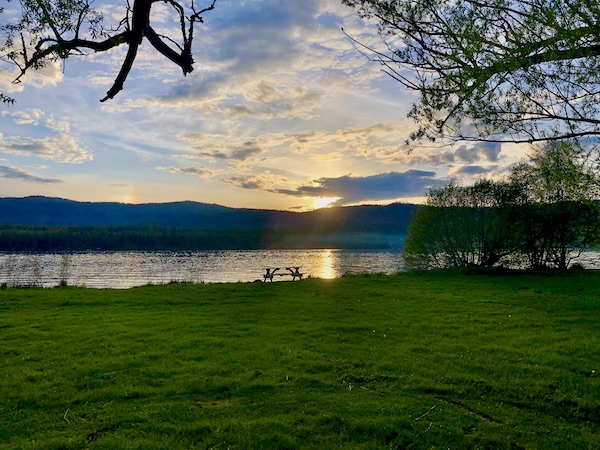 Setting sun over a lake while Visiting Spokane Washington