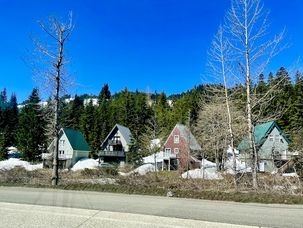 Colorful A-fame homes nestled in the woods along our route for Visiting Spokane Washington