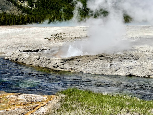 Hot springs by a river in Yellowstone National Park Wyoming