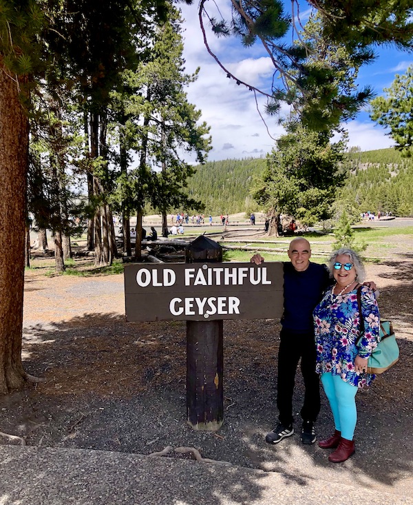 Steve and I standing by the sign for Old Faithful.