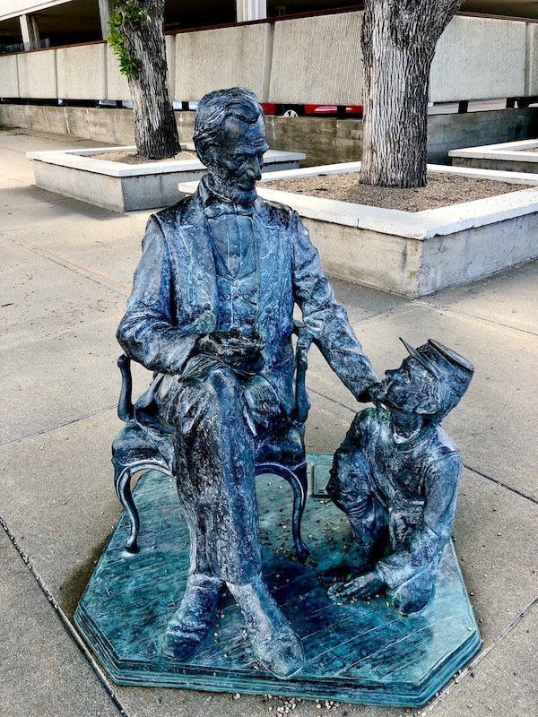 Seated verde gris statue of Abe Lincoln with his youngest son Tad in Rapid City