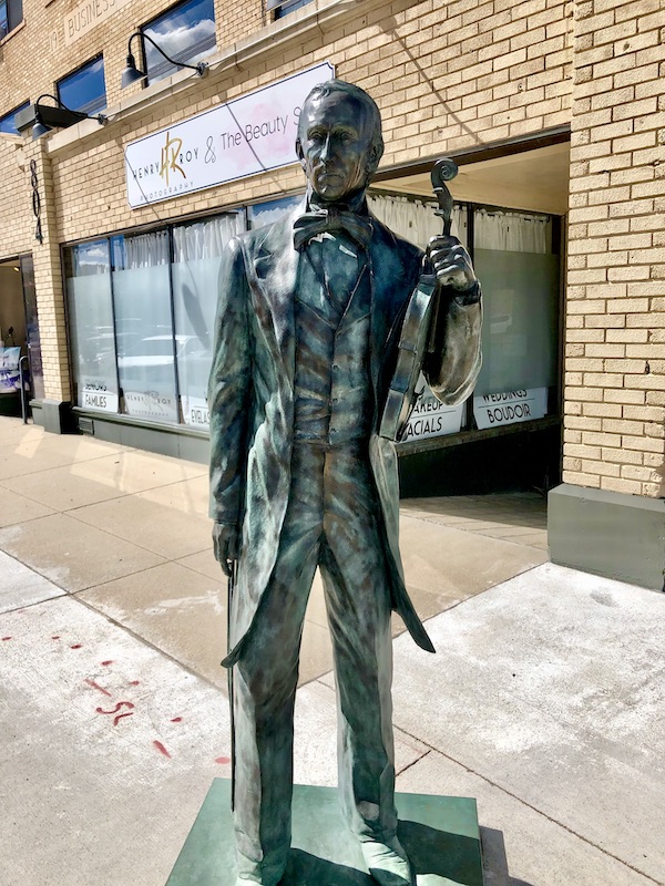 Statue of John Tyler holding a violin and bow in Rapid City SD