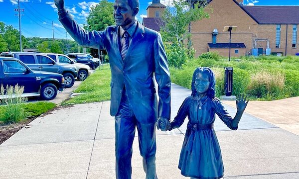 Bronze statue of Barack Obama holding hands with daughter Sasha, part of the American Presidents of Rapid City SD