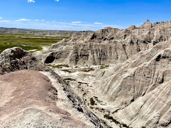 Rock formations popping out of grass for miles at Badlands National Park SD