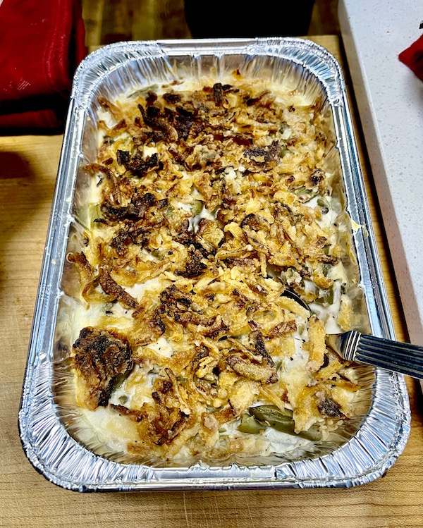 Green bean casserole in a disposable pan for a Happy Thanksgiving 2022!