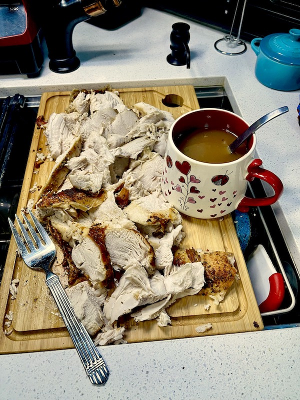Sliced turkey breast with a cup of rich brown gravy for a Happy Thanksgiving 2022!