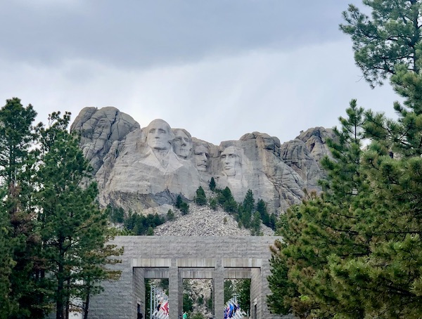 Carved faces of the 4 presidents on Mount Rushmore before the parade of flags