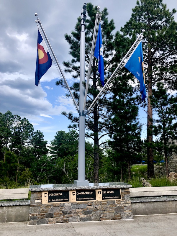 A trio of flags along the walkway to Mount Rushmore