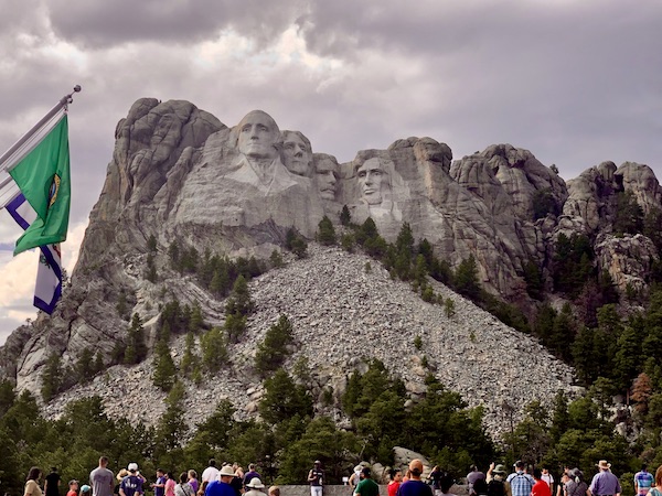 Crowd of people viewing Mount Rushmore National Memorial
