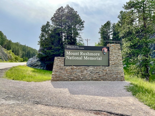 Stone and wood sign welcomes you to Mount Rushmore National Memorial