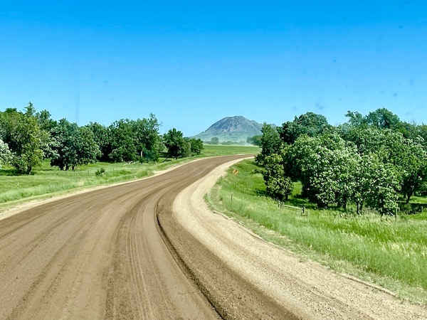 Dirt road with mountain in the distance en route to Theodore Roosevelt National Park ND