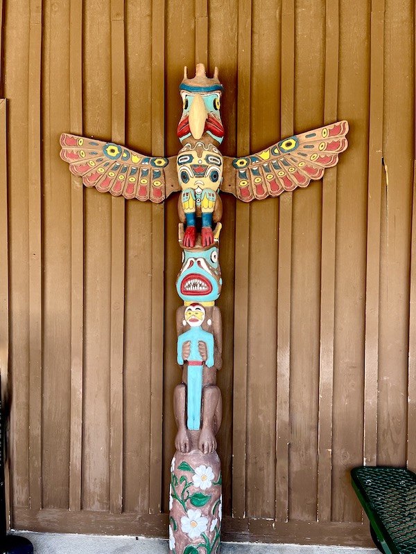 Totem with eagles wings at top in Wall Drugs Backyard