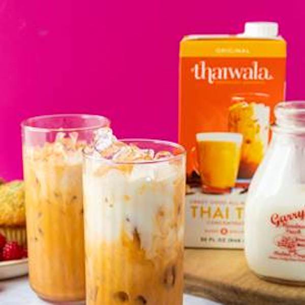 Glasses of tea with milk and an orange box of tea concentrate, part of my 2022 Holiday Gift Guide