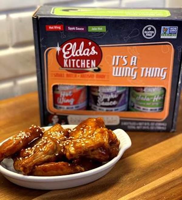 Orange box holding 3 bottles of sauce next to a plate of wings covered in sauce and sesame seeds, part of my 2022 Holiday Gift Guide