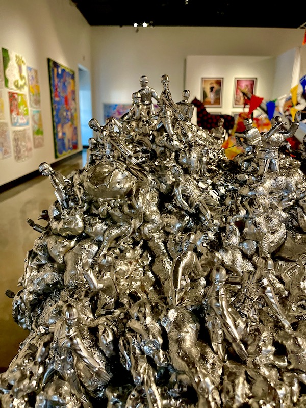 Sculpture of huge number of silver toy soldiers atop an army green foot locker in Fargo North Dakota