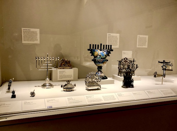 Assorted menorahs and dreidels on display