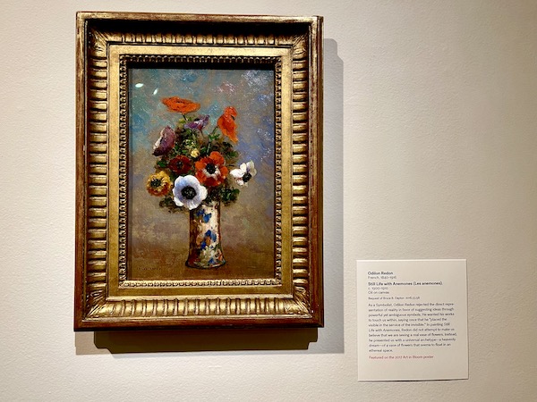 Painting of red and white anemones in a vase framed in gilded wood.