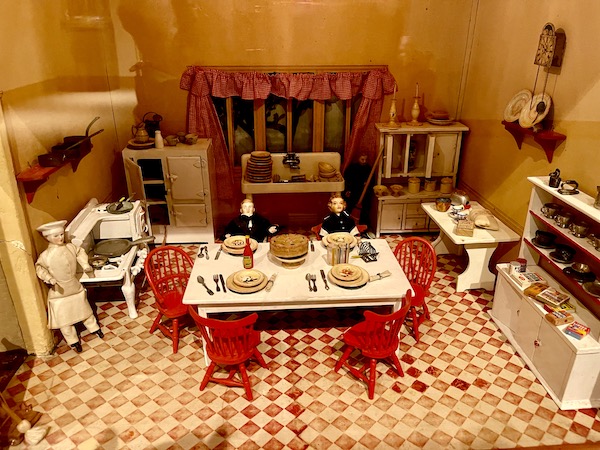 Miniature kitchen in red and white complete with set dining table and chairs on display at the Minneapolis Institute of Art