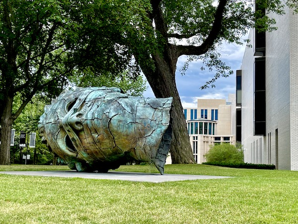 Giant weathered bronze head of a Greek or Roman on the lawn of the Minneapolis Institute of Art