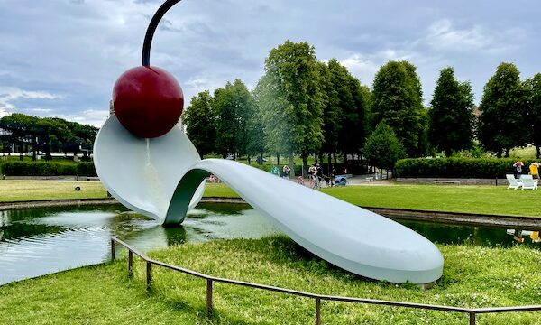 White spoon sculpture with red cherry at top on lawn at Minneapolis Sculpture Garden Minnesota
