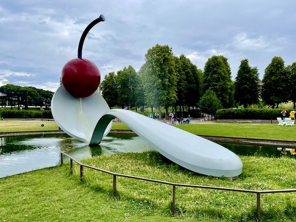 White spoon sculpture with red cherry at top on lawn at Minneapolis Sculpture Garden Minnesota