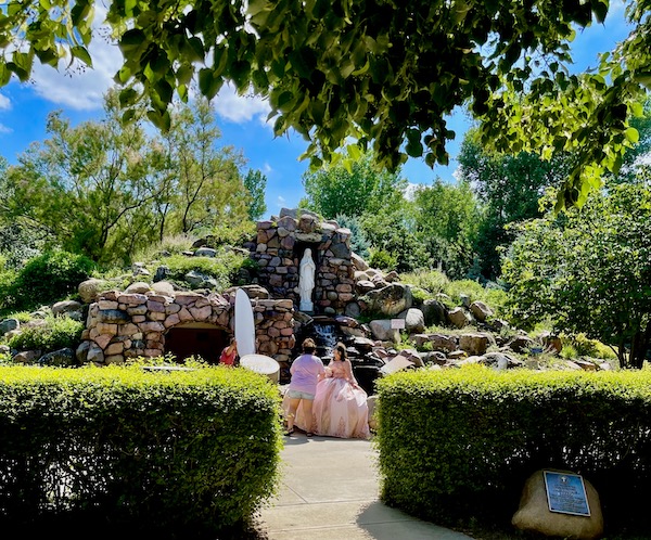 Girl in pink ball gown posing for photographer at Trinity Heights Sioux City IA