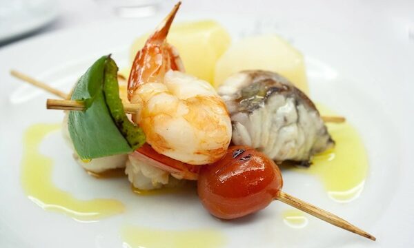 Assorted seafood on a skewer with cherry tomato and green pepper for another way of Incorporating Seafood into Your Social Occasions