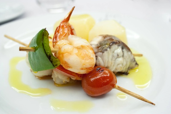 Assorted seafood on a skewer with cherry tomato and green pepper for another way of Incorporating Seafood into Your Social Occasions