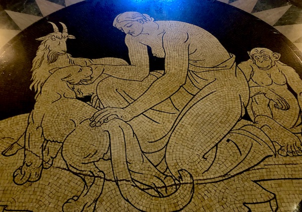 White and black marble mosaic on the floor of the On the floor are three mosaics which represent the Earth, “The Spirit of the Soil”, “The Spirit of Vegetation” and “The Spirit of Animal Life”. The three medallions in the ceiling represent “Traditions of the Past”, “Life of the Present” and “Ideas of the Future”.