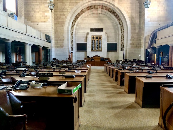 Huge legislative chamber with rows of desks at the Nebraska State Capitol in Lincoln