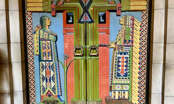 Colorful Native American themed hand carved wood doors in the Nebraska State Capitol in Lincoln