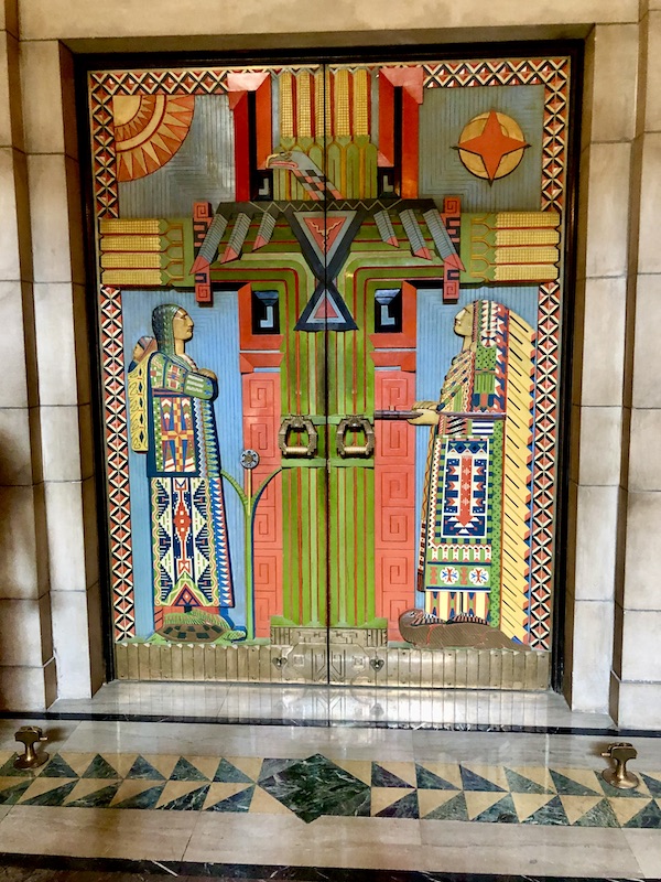 Colorful Native American themed hand carved wood doors in the Nebraska State Capitol in Lincoln