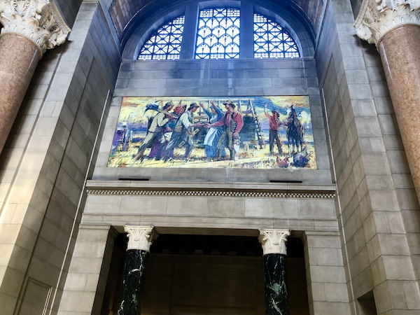 Mural in arch of Nebraska State Capitol in Lincoln vestibule shows farmers with tools