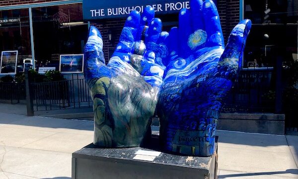 Sculpture of a pair of hands painted blue with artwork was just Some Highlights of Lincoln NE