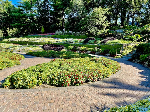 Brick path and zinnias among other plants at the Sunken Gardens Lincoln Nebraska