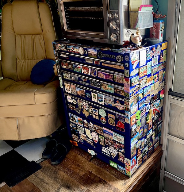 Blue mechanic's tool chest covered in souvenir magnets.