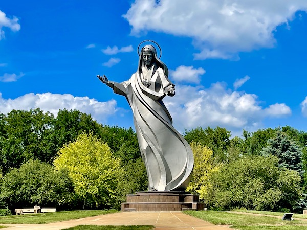 Huge stainless steel sculpture of the Queen of Peace at Trinity Heights Sioux City IA