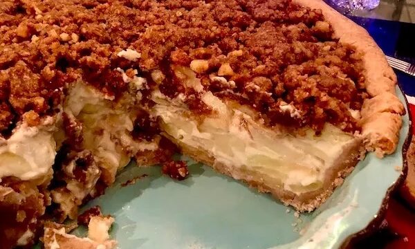 Aqua pie plate filled with candied apple walnut pie.