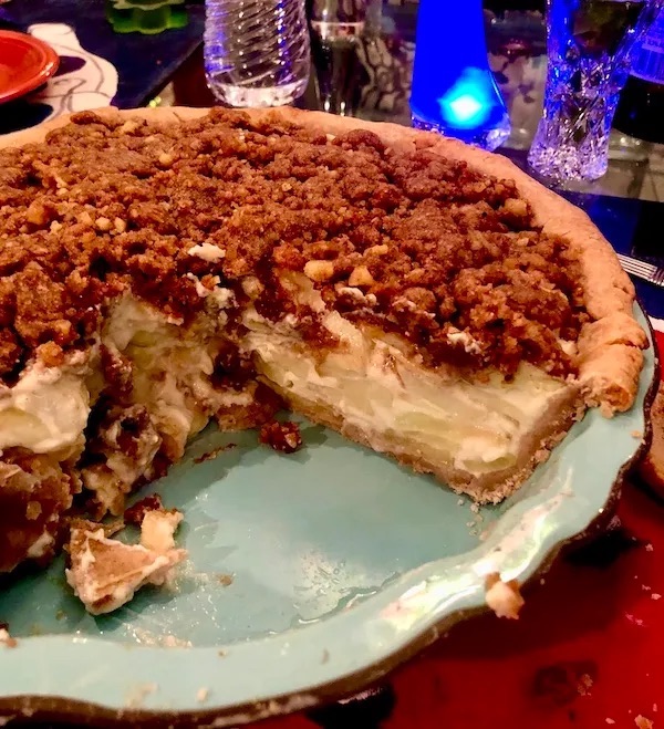 Aqua pie plate filled with candied apple walnut pie.