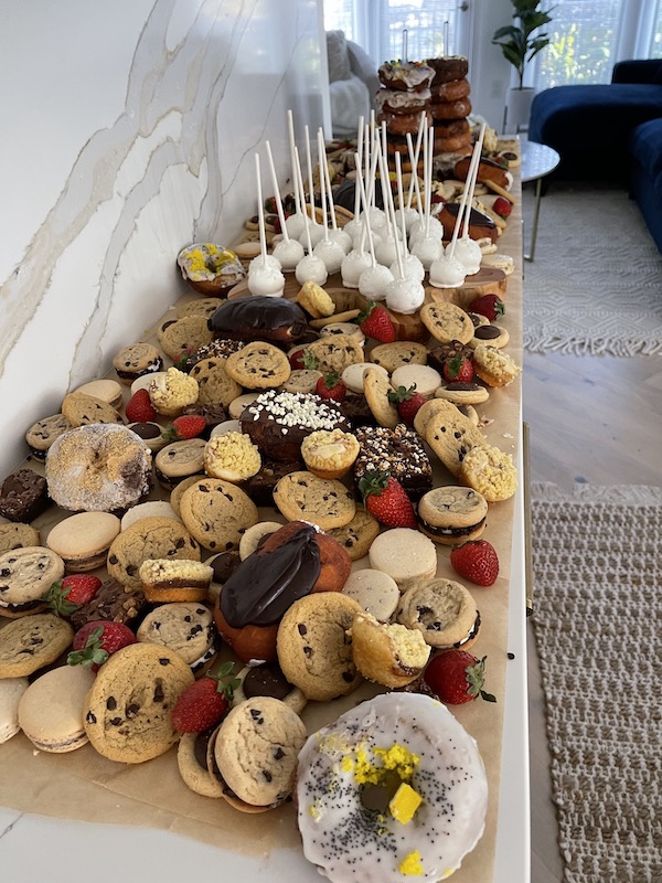 Long countertop covered with assorted cookies, one of 8 Ways to Celebrate With Food
