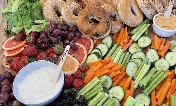 Crudités, dips, fruit, bagels, cheeses, smoked fish platter ready for a celebration.