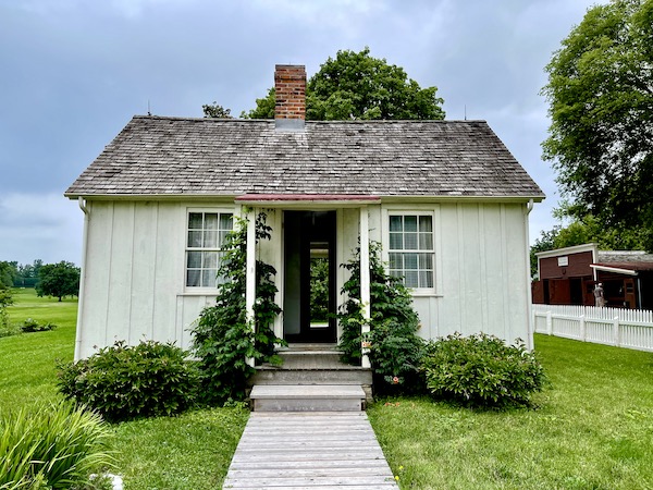 Small pale green, 2 room house with landscaping at the Herbert Hoover National Historic Site Iowa