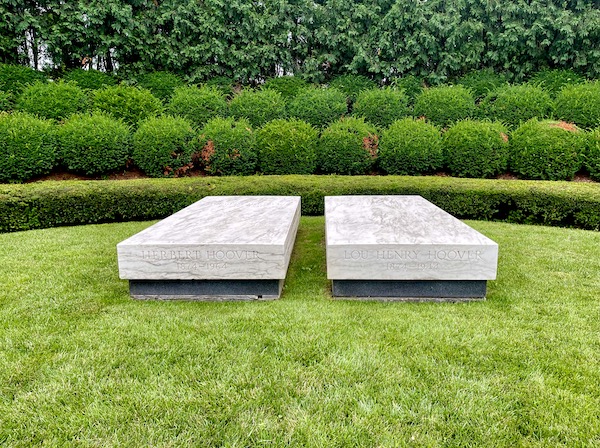 Lawn, bushes and 2 white rectangular grave markers at the Herbert Hoover National Historic Site Iowa